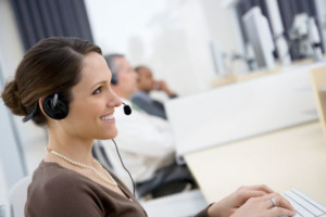 Smiling businesswoman wearing headset in office